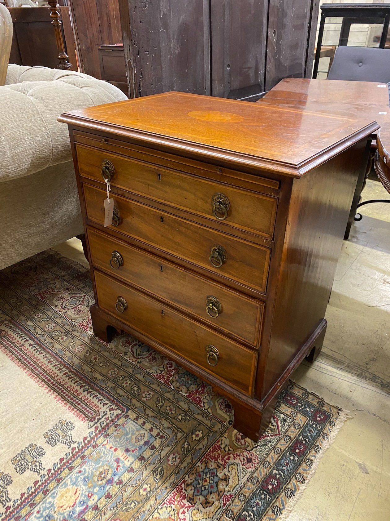 A small George III style satinwood inlaid mahogany four drawer chest with slide, width 67cm, depth 44cm, height 75cm